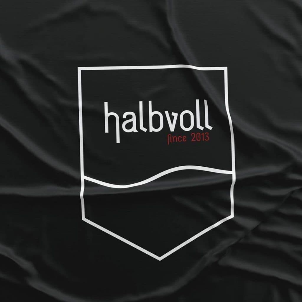 Halbvoll shooting-club flag: the wordmark set in Zeche, white on black fabric